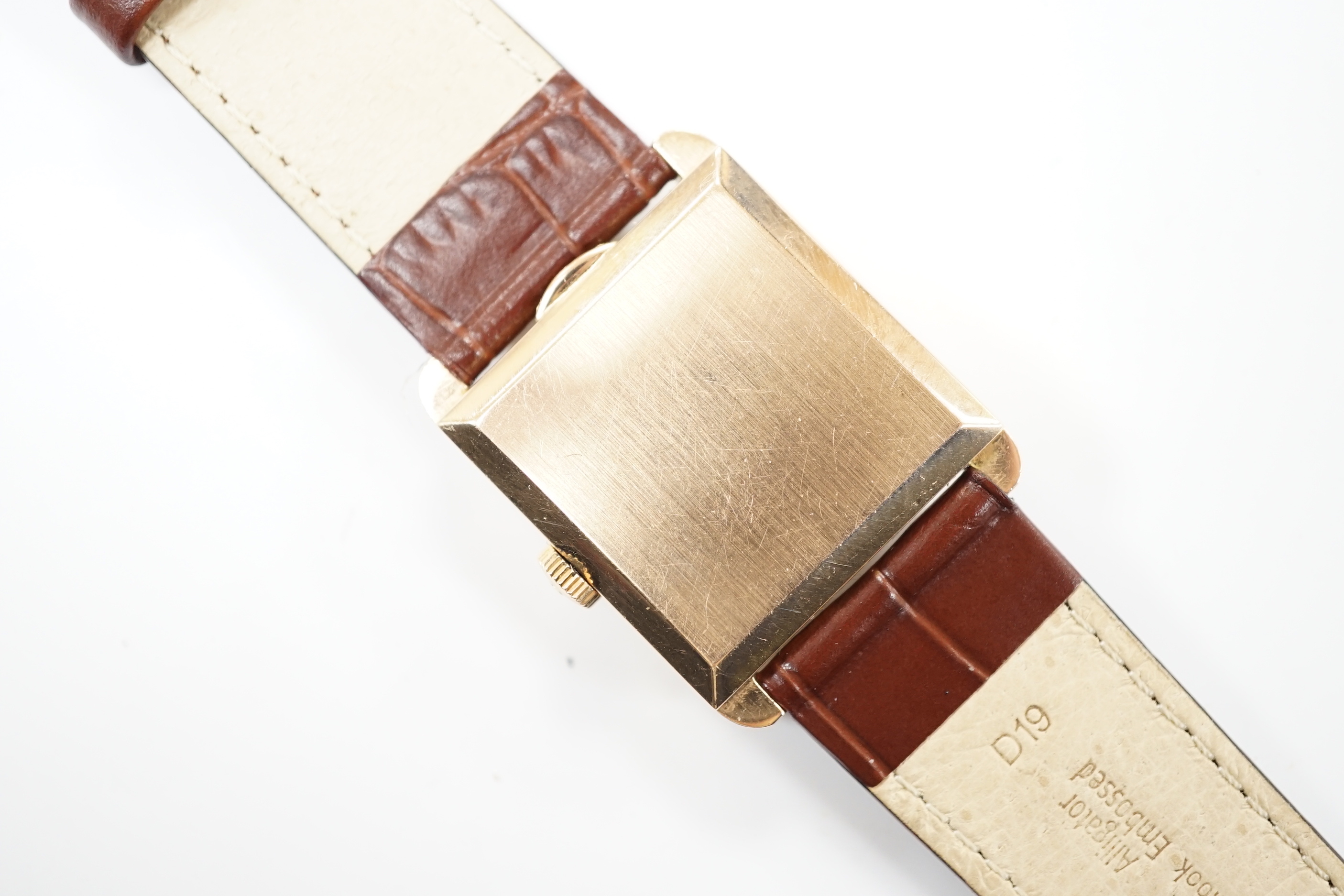 A gentleman's 18ct gold Jaeger LeCoultre manual wind dress wrist watch, with square dial, milled bezel and baton and quarterly Arabic numerals, on associated leather strap, case diameter 26mm, gross weight 31.8 grams.